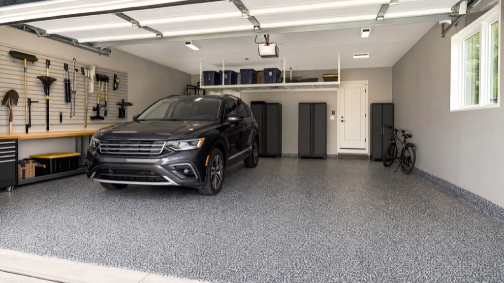 Coated garage floor with an SUV parked on it and cabinets along the back wall