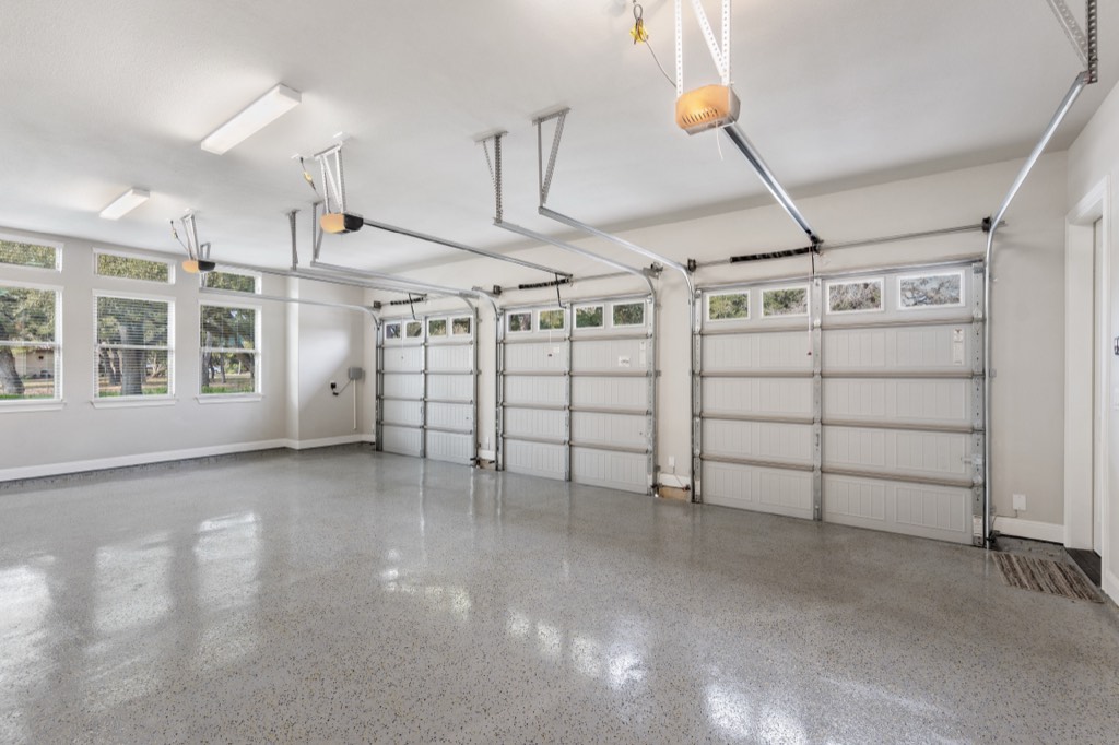 Light flake floor in a clean white-walled garage with windows along one side