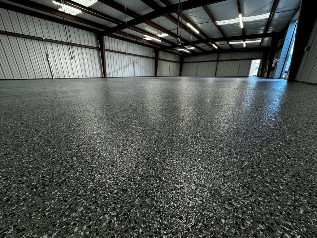 Dark flake floor in a steel-framed workshop building